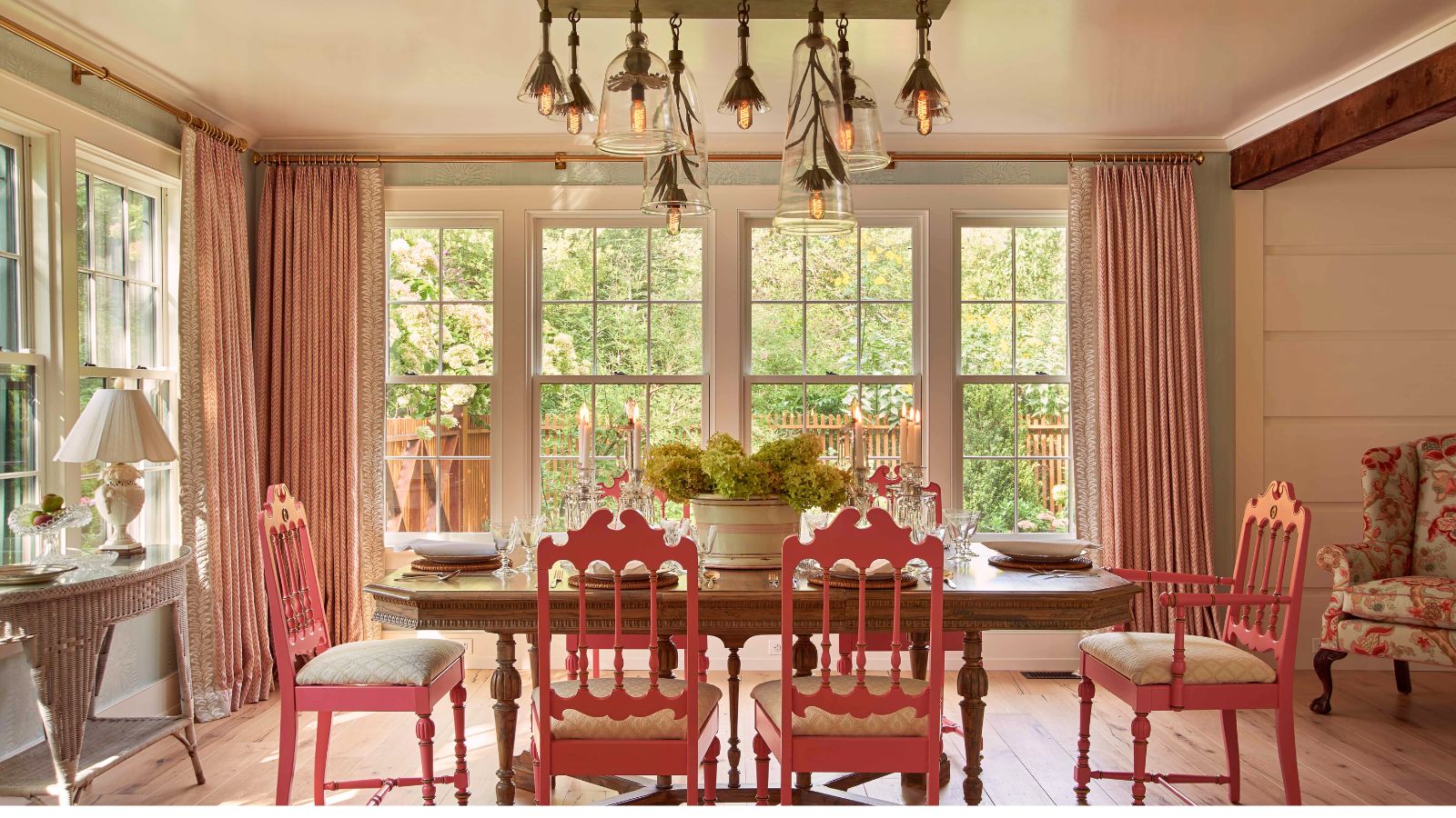 Dining room with large windows featuring a table and chairs bought at an estate sale