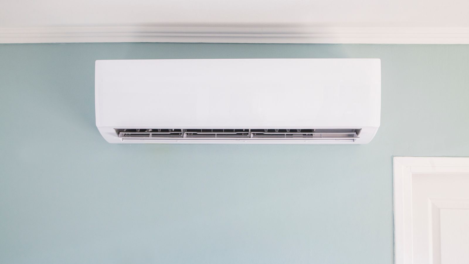White AC unit on light blue wall